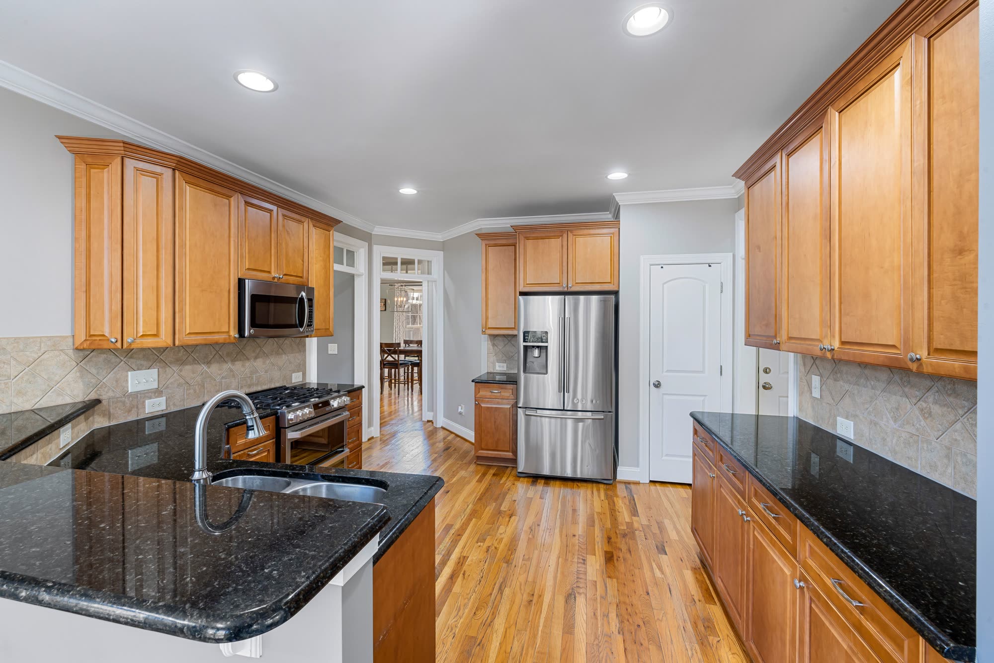 Finished kitchen with wood cabinets, granite countertops and stainless steel appliances