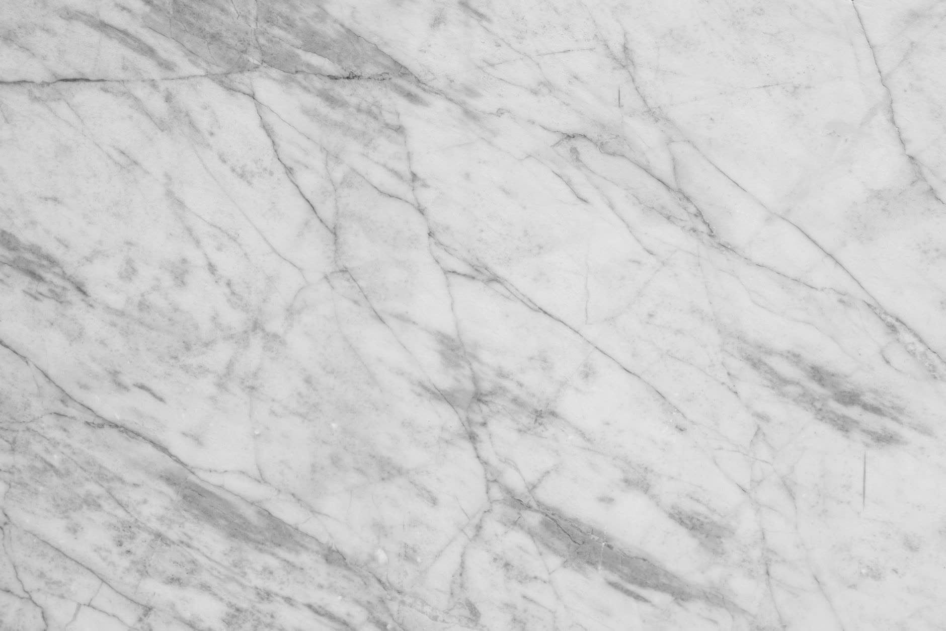 Polished granite countertop showing natural black and white veining, polished finish with grain patterns and lustre in a professional kitchen setting